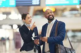 Um casal conversando em um ambiente de aeroporto.